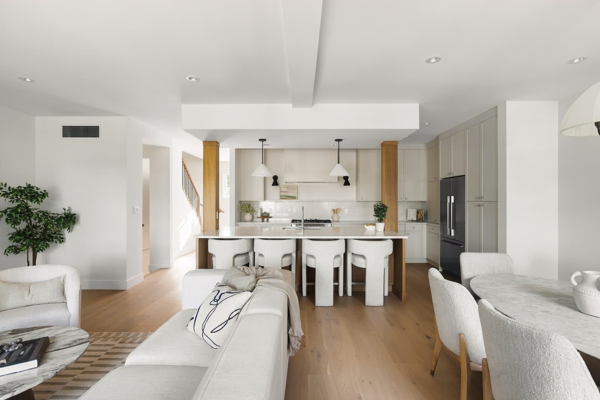 The main floor from the living room, past the dining table to the kitchen