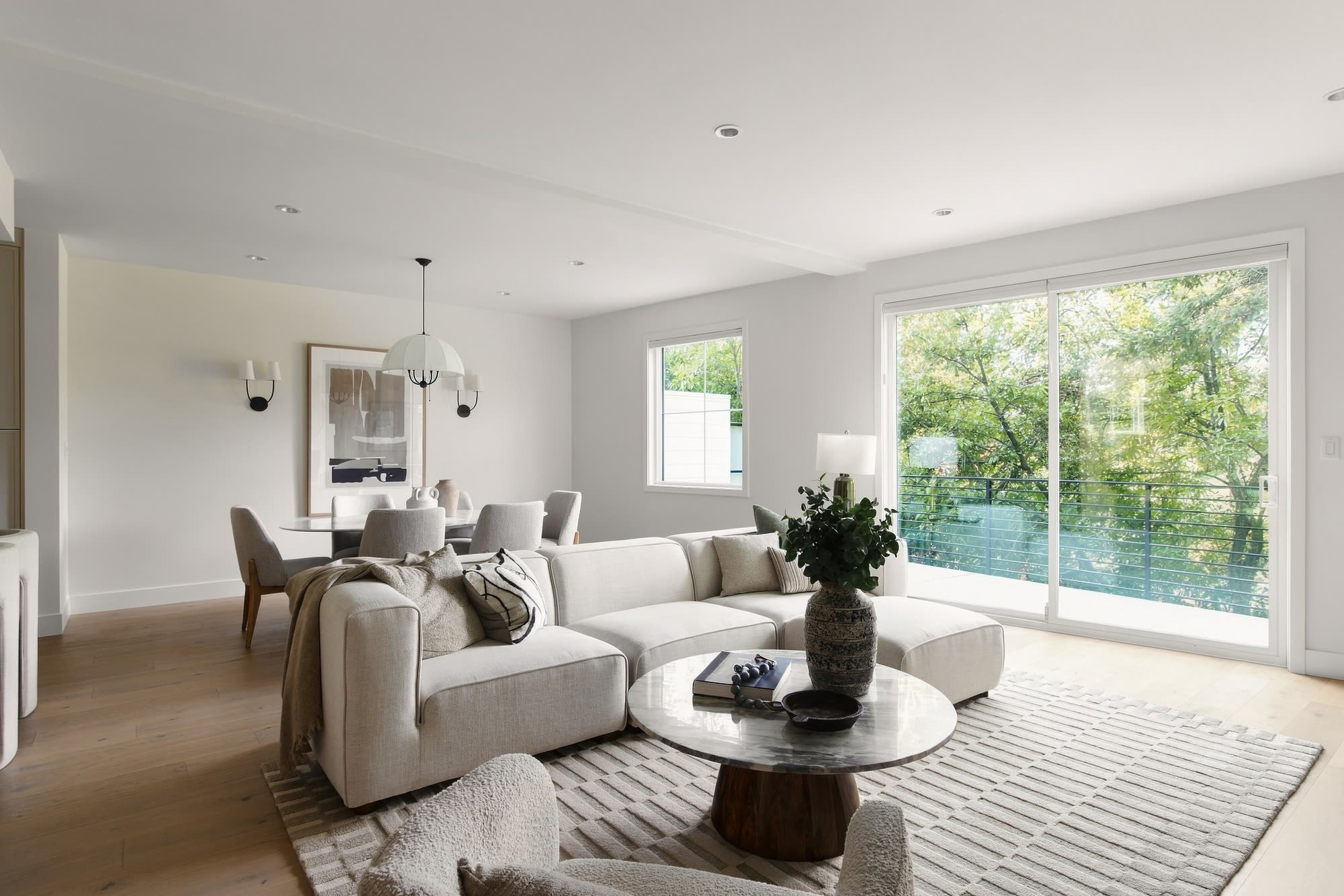 The living and dining room, with a wide slider out to the trees