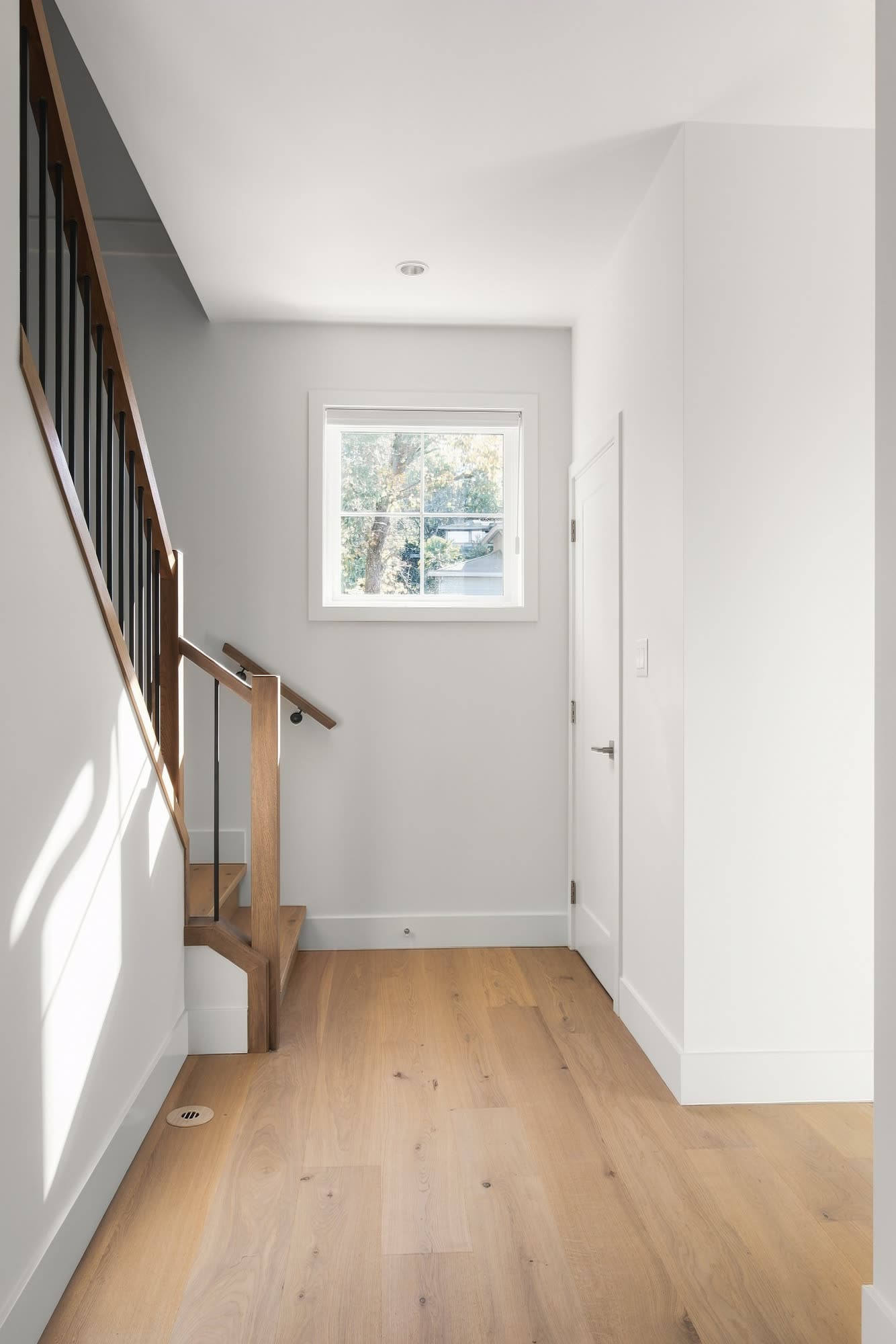 The downstairs hall to the powder room, with the oak stair up