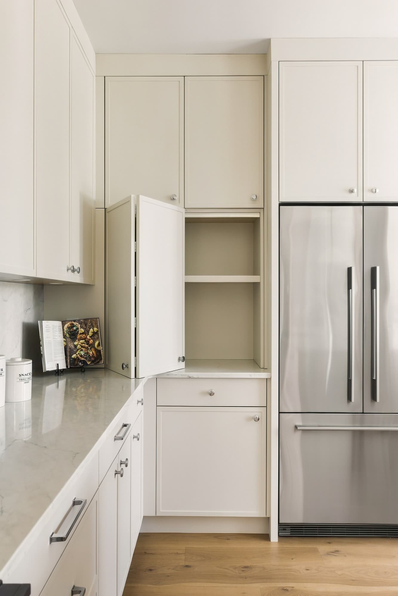 The same wall with one cabinet open on deep shelves