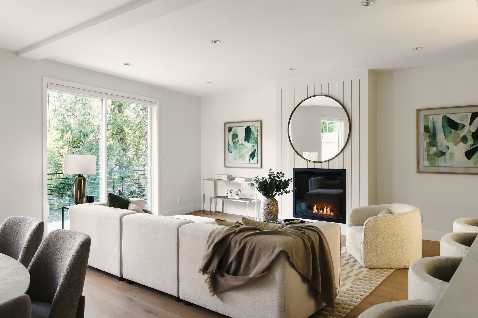 Home 1: the living room, with the fireplace under a round brass mirror