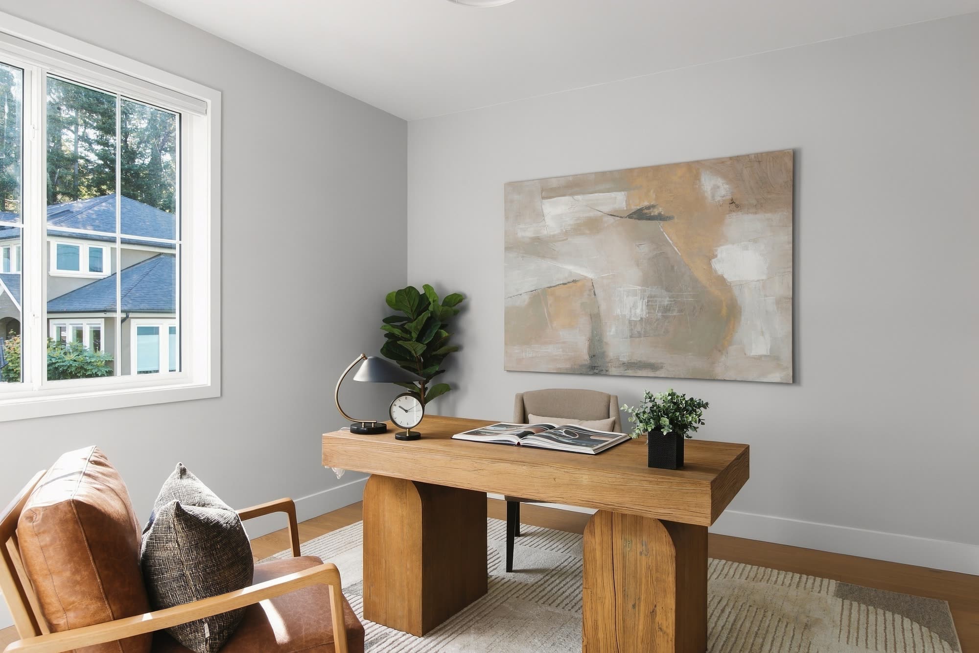 The office, with an oak desk, a leather chair and a window