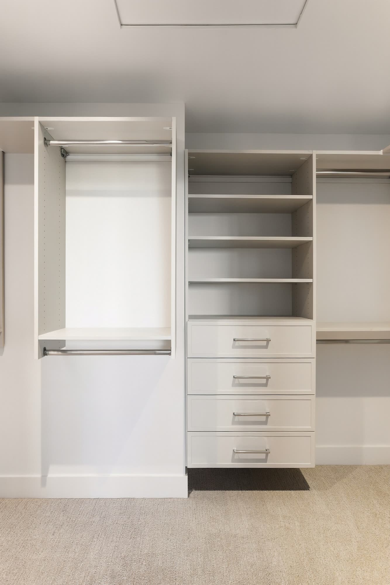 The walk-in closet, with hanging rails, shelves and drawers