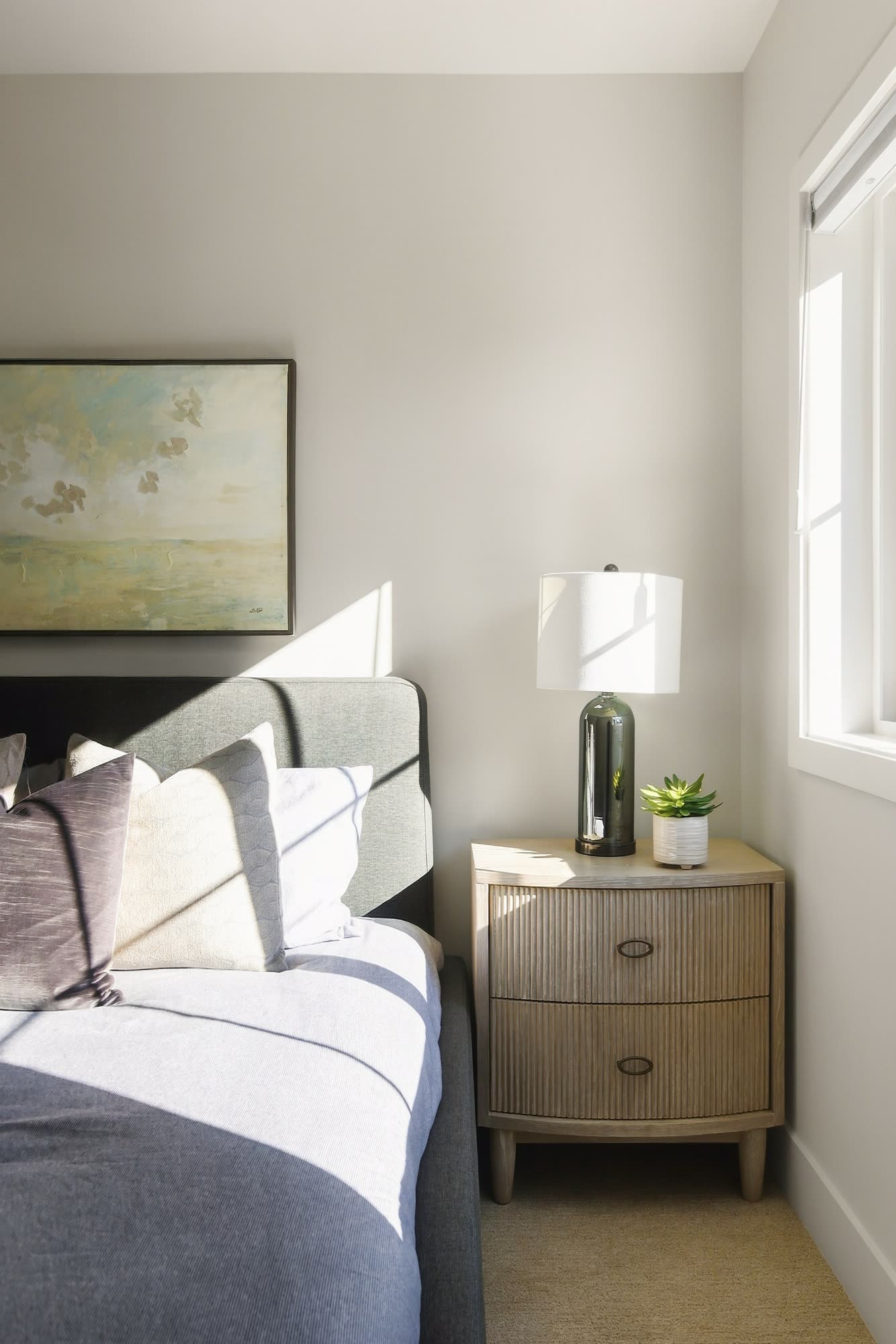 A bedside table and lamp beside the bed