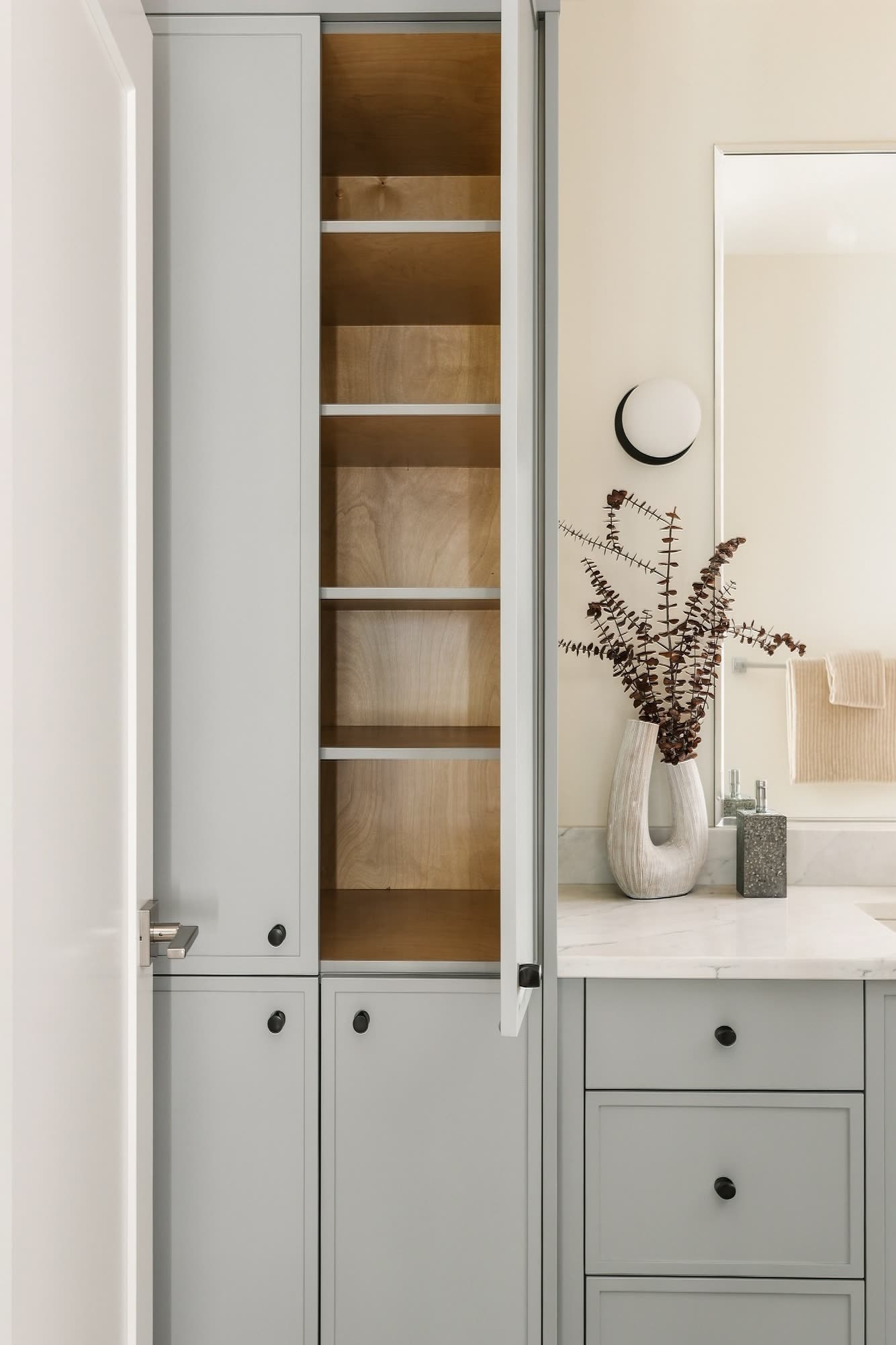 Bathroom storage: a tall cabinet with open oak shelves