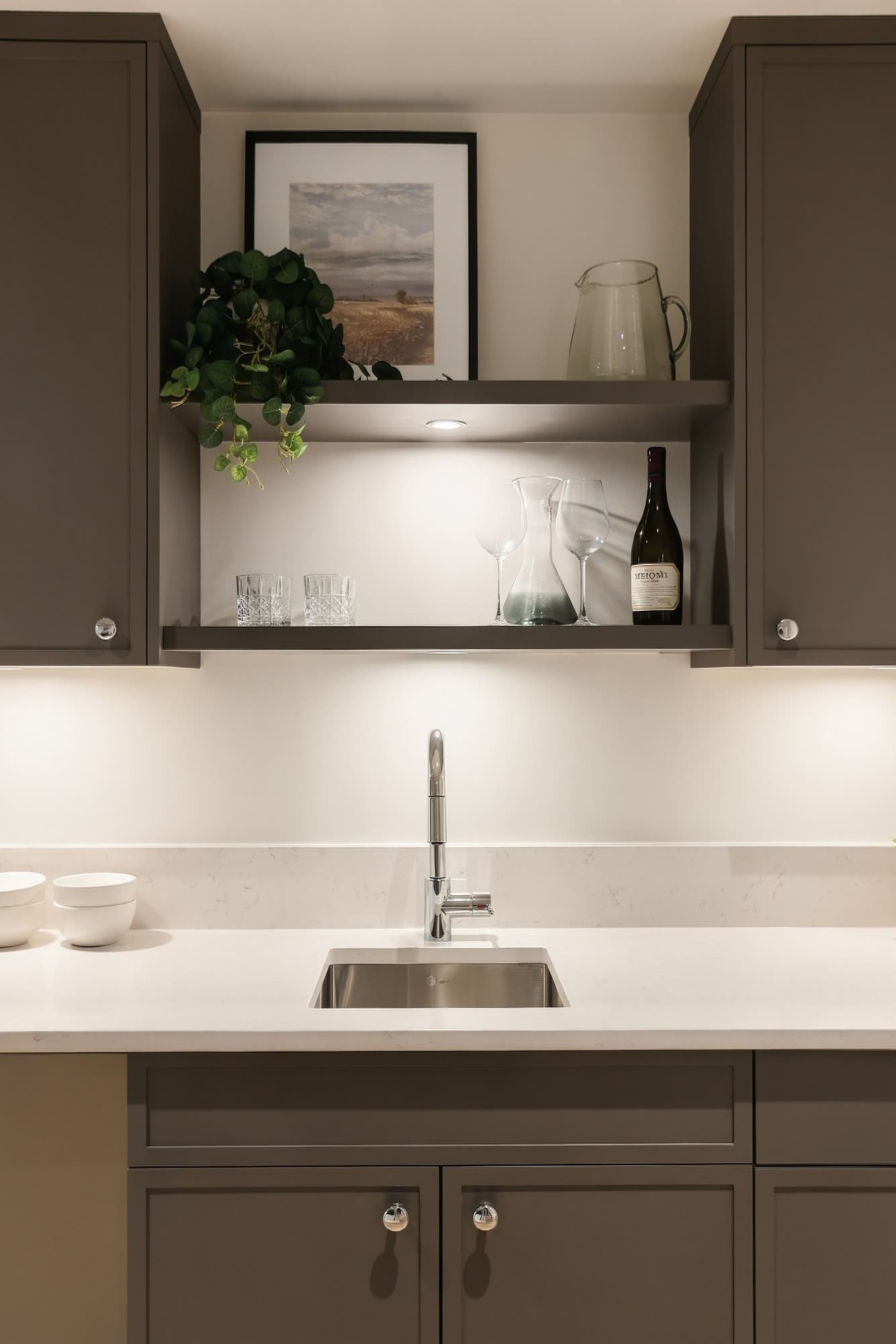 Open shelves and a bar sink at the wet bar